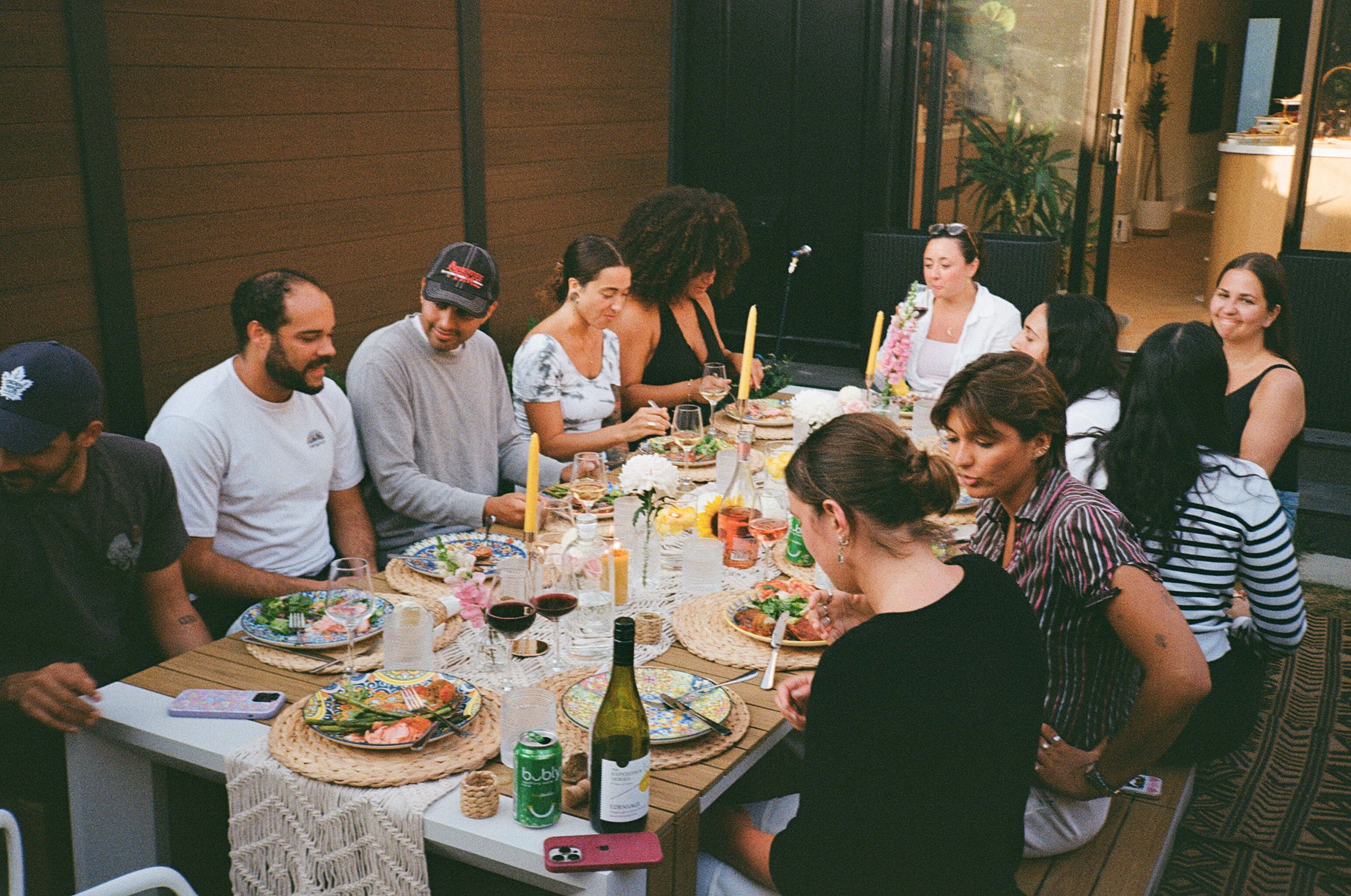 Friends gathered around a dinner table outside
